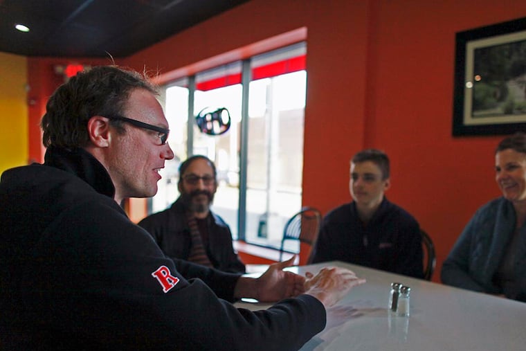 Stephen Danley, left, talks with fellow members of the Camden Supper Club during a gathering at the Reggae Grill on Federal Street in Camden on March 24, 2015. ( Joseph Kaczmarek / For the Inquirer )