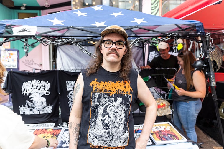 Jim Anderson, 35, of Roxborough, Pa., Graphic Designer and owner of GrimGrimGrim, poses for a portrait at his tent during a popup event in South Philadelphia, Pa., on Saturday, Aug., 26, 2023.