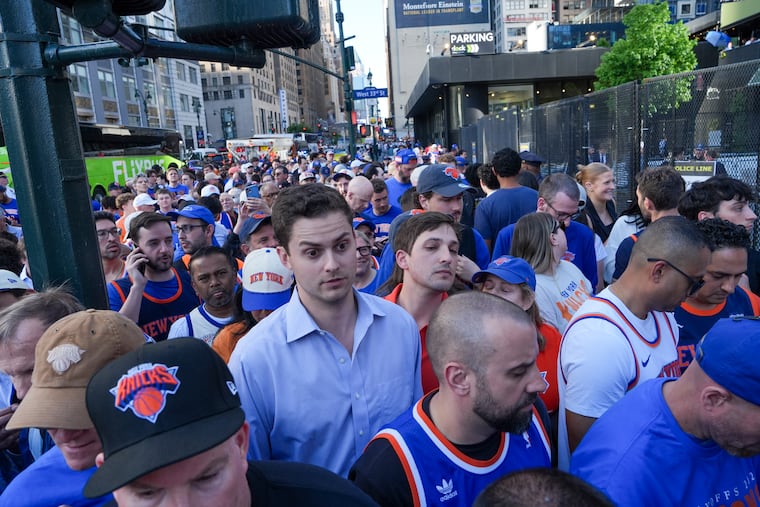New York Knicks fans wait in line to enter Madison Square Garden ahead of Game 3 of the NBA Finals on Monday.