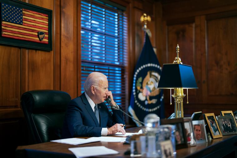 In this file image provided by The White House, President Joe Biden speaks with Russian President Vladimir Putin on the phone from his private residence in Wilmington, Del., Dec. 30, 2021. Biden acknowledged on Thursday that a document with classified markings from his time as vice president was found in his “personal library” at his home in Wilmington, Delaware, along with other documents found in his garage, days after it was disclosed that sensitive documents were also found at the office of his former institute in Washington.