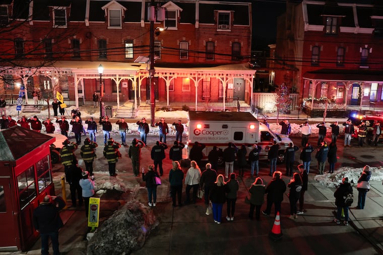 People line the street during a dignified transfer from Cooper Hospital for the Camden firefighter who died after falling into the Delaware River while conducting routine maintenance on a fire boat, Thursday, Feb. 5, 2026, in Camden, NJ.