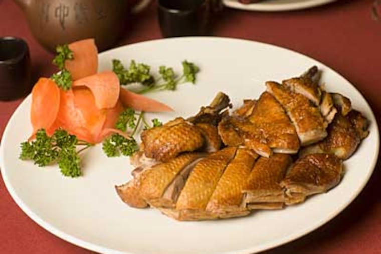 tea-smoked duck, intensely smoky and exuding spice. The food, on the whole, is worth the drive. (ED HILLE / Staff Photographer)