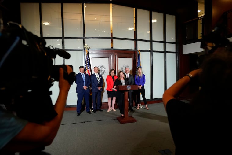 Pennsylvania Attorney General Michelle Henry speaks during a July 7 news conference in Philadelphia. A Pennsylvania grand jury investigating child sexual abuse in the Jehovah's Witnesses community has charged an additional five people with raping or molesting children as young as 4, the latest developments in an ongoing probe that has identified 14 suspects.
