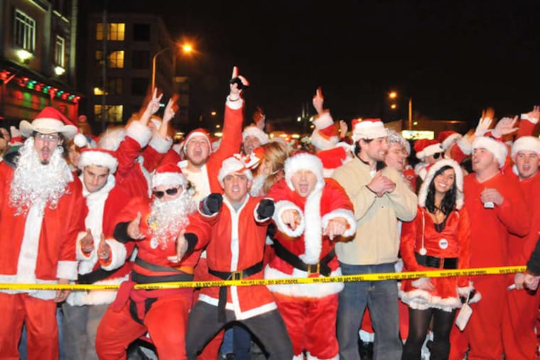 Pub-crawling Mrs. Clauses at the 2012 Santas run. About 10,000 are likely to participate Saturday, ending with a music showcase at the Electric Factory.