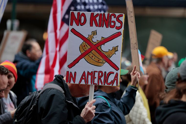 A man carries a "NO KINGS IN AMERICA" sign during the "Hands Off!" National Day of Action demonstration in Philadelphia in April.