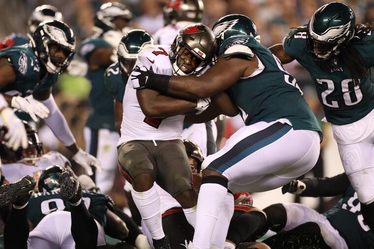 Eagles tackle Fletcher Cox tackling Tampa Bay's Leonard Fournette during their game on Oct. 14.