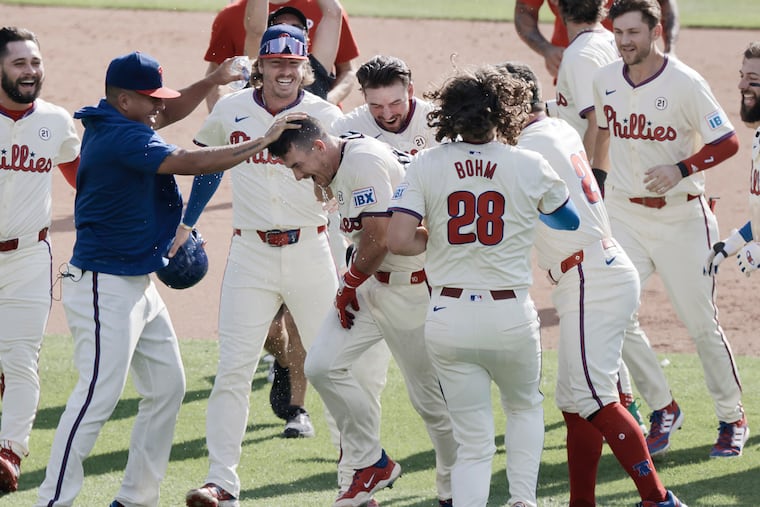 J.T. Realmuto (fourth from left) and his Phillies teammates celebrate a win over the Mets on Sept. 15.