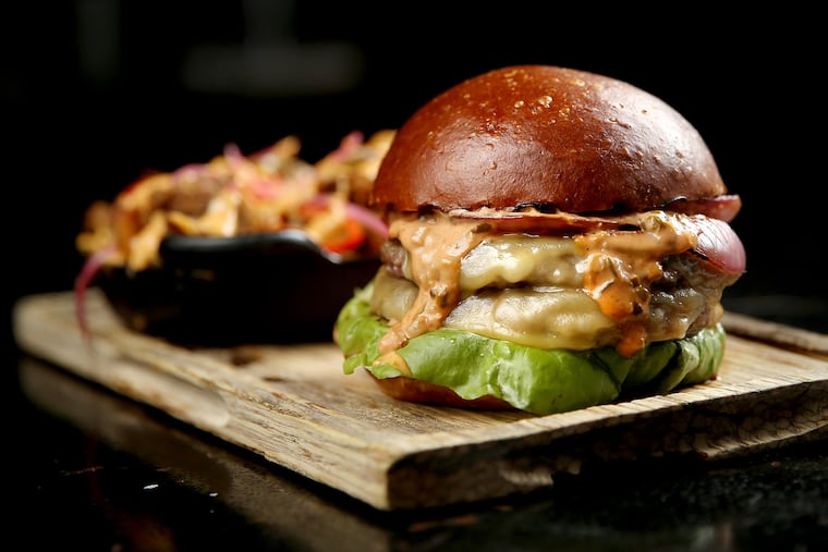 The burger is pictured with Ripp Fries at Ripplewood Whiskey & Craft in Ardmore, Pa., on Friday, Aug. 30, 2019.