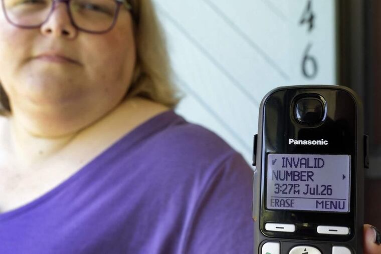 A Florida woman shows a robocall she received on her home phone in Orlando. Despite consumer awareness, state and federal efforts to crack down, and apps for blocking unwanted calls, robocalls have increased dramatically in the first half of 2018.