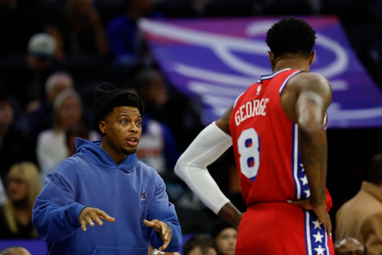 Sixers guard Kyle Lowry talks to teammate Paul George during the game against the Cleveland Cavaliers on Jan. 24. He's embraced being "Coach Lowry" when he's not on the court.