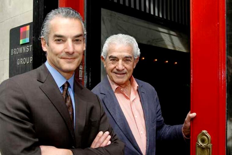 Berny,R, and son Marc Bernstein pose in front of their building on Broad st. A look at a small business that has entered its second generation to become the longest-running advertising agency in Philadelphia -- the Brownstein Group. Having just won an ADDY, the 70-person firm on Broad Street still hasn't lost its creative mojo after 50 years.photos taken on Monday, May 5, 2014. ( RON CORTES / Staff Photographer ).