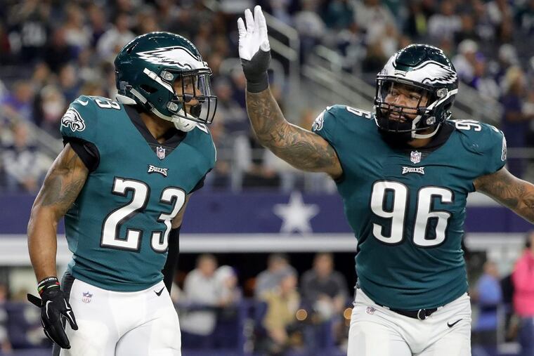 Eagles rookie Derek Barnett, right, celebratiing with Rodney McLeod after McLeod scored on an interception against the Cowboys in the teams’ first meeting last month.