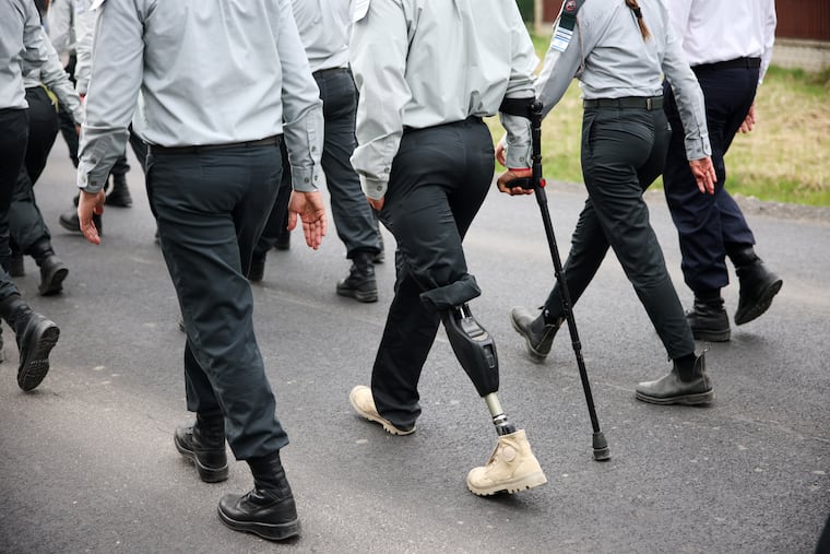 People take part in the annual "March of the Living" to commemorate the Holocaust, a yearly march between the former death camps of Auschwitz and Birkenau, in Oswiecim, Poland, on Tuesday.