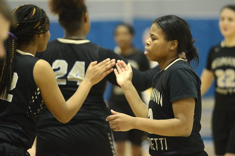 Neumann-Goretti’s Angel Ricks (left) and Kiara Koger celebrate after defeating St. Basil Friday night.