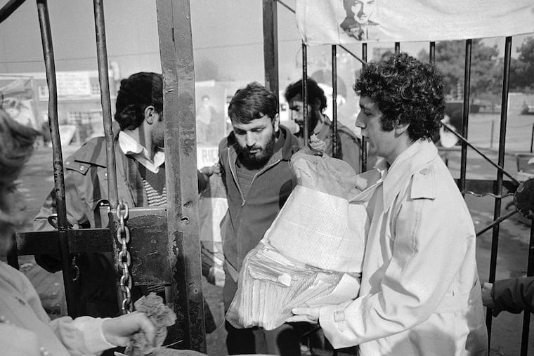 Radio reporter Alex Paen delivers a sack of Christmas cards sent to the U.S. hostages from well-wishers in the U.S. to Tehran, Iran, Dec. 17, 1979. Guards accepted the mail and said it would be distributed after inspection.