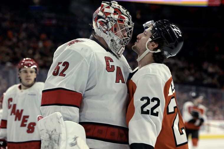 Flyers right wing Jakob Pelletier (right) and Hurricanes goalie Pyotr Kochetkov exchange words in the second period of their game at th Wells Fargo Center on Saturday.