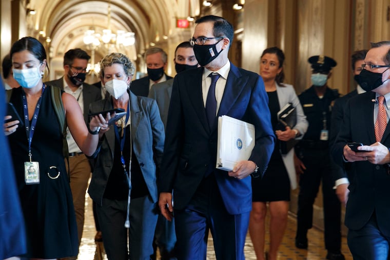 Treasury Secretary Steven Mnuchin, center, walking to a Republican luncheon Tuesday while attending meetings on Capitol Hill in Washington. In the background at center left is White House Chief of Staff Mark Meadows.