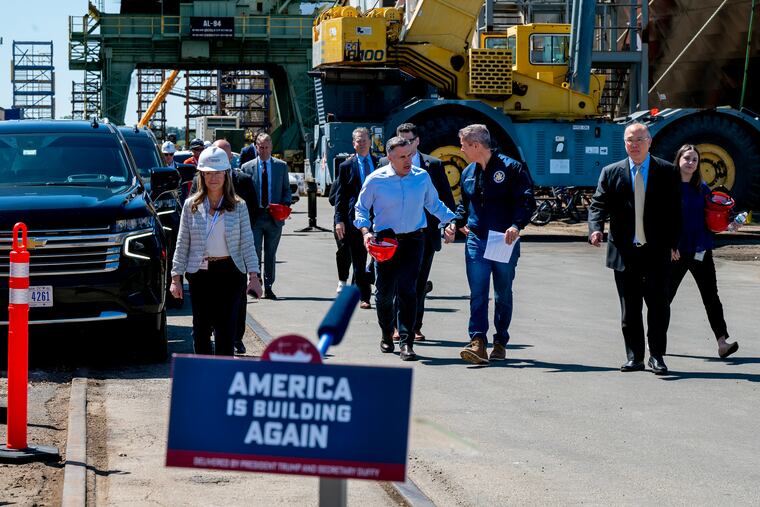 Transportation Secretary Sean Duffy walks with U.S. Sen. Dave McCormick and shipyard CEO David Kim (right) following a tour of the Hanwha Philly Shipyard in April.