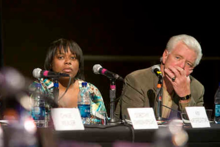 During the district attorney debate, survivor panelists Kim Hartsfield-Stokes and Larry McDonald listen to candidates' comments.