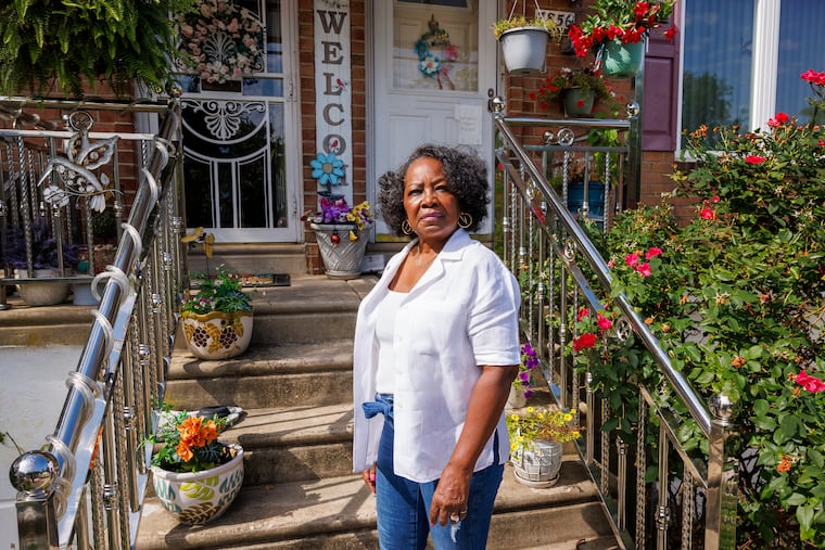 Brenda Whitfield, long-time resident of the Eastwick neighborhood of Philadelphia, in front of her home.