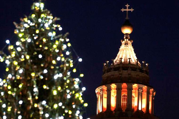 St. Peter's Basilica is framed by the 82-foot Christmas tree lit up at the Vatican on Friday. Ukraine supplied the tree.