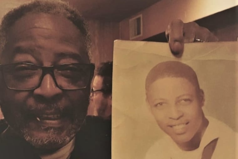 Mr. James poses with a photo from his days in the Navy. He served on the USS Bonn Homme Richard aircraft carrier in the 1960s.