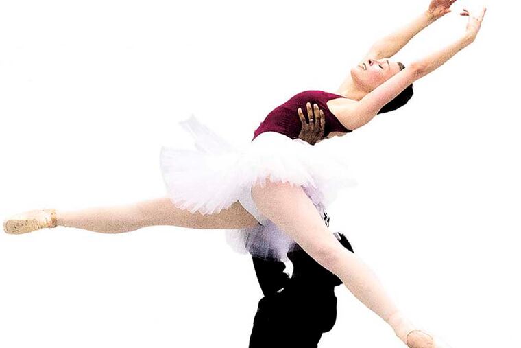 Elizabeth Mateer, 24, a rising star in the Pennsylvania Ballet Company, rehearses one of her dances for the upcoming performance of the Nut Cracker Ballet with a partner Nov. 18, 2014. ( CLEM MURRAY / Staff Photographer )