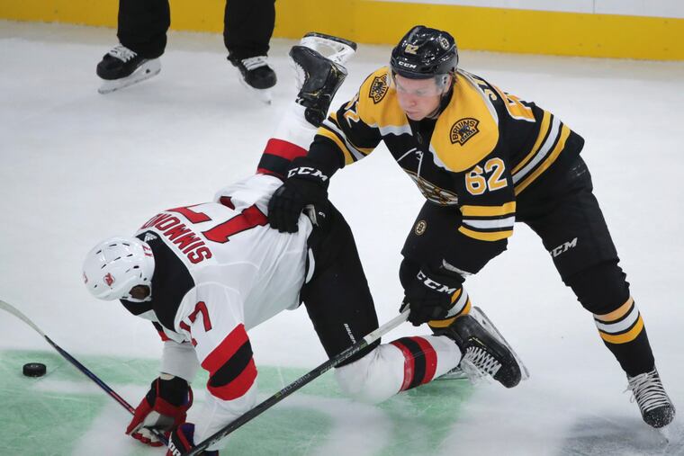 Boston's Oskar Steen (right) drops the Devils' Wayne Simmonds during a preseason game.