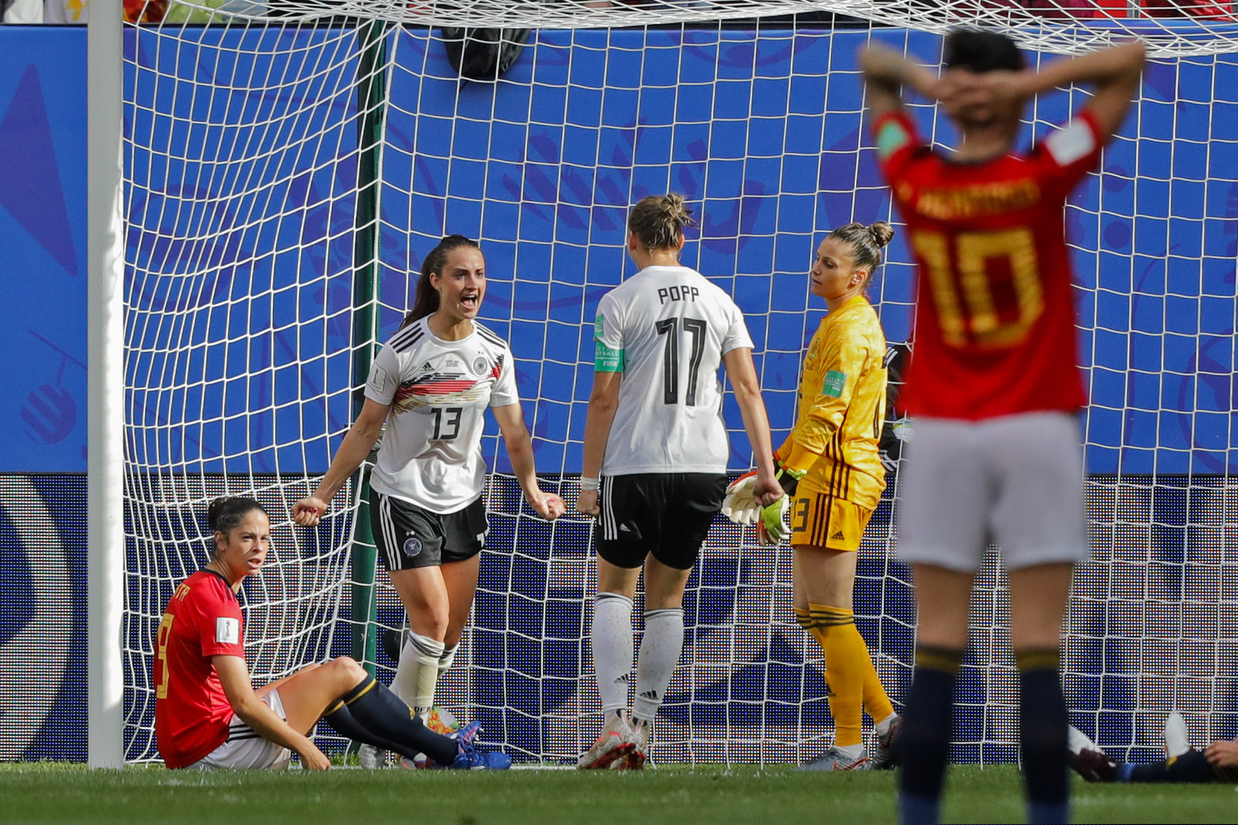 Germany's Sara Daebritz, top left, celebrates after scoring against Spain.