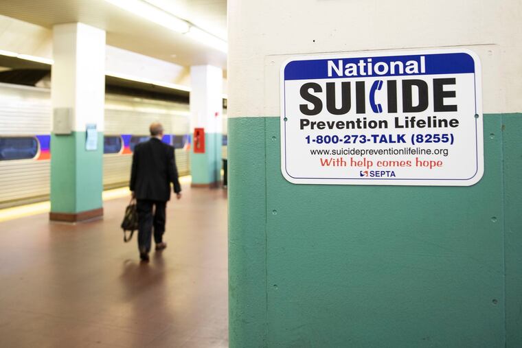 A sign for suicide prevention, photographed on the train platform at Suburban Station in Center City Philadelphia on Oct. 31, 2019.