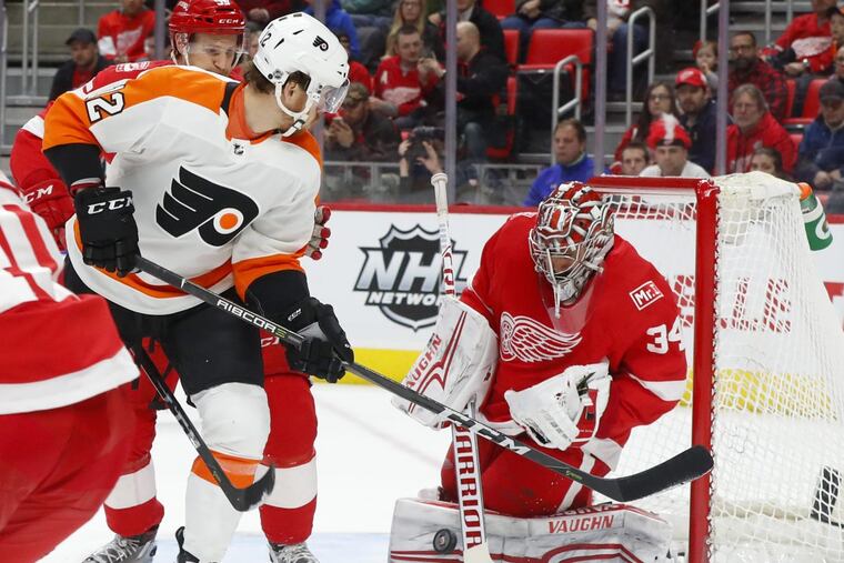 Detroit goaltender Petr Mrazek stops left winger Michael Raffl (12) in the Flyers’ 3-2 overtime win Tuesday.