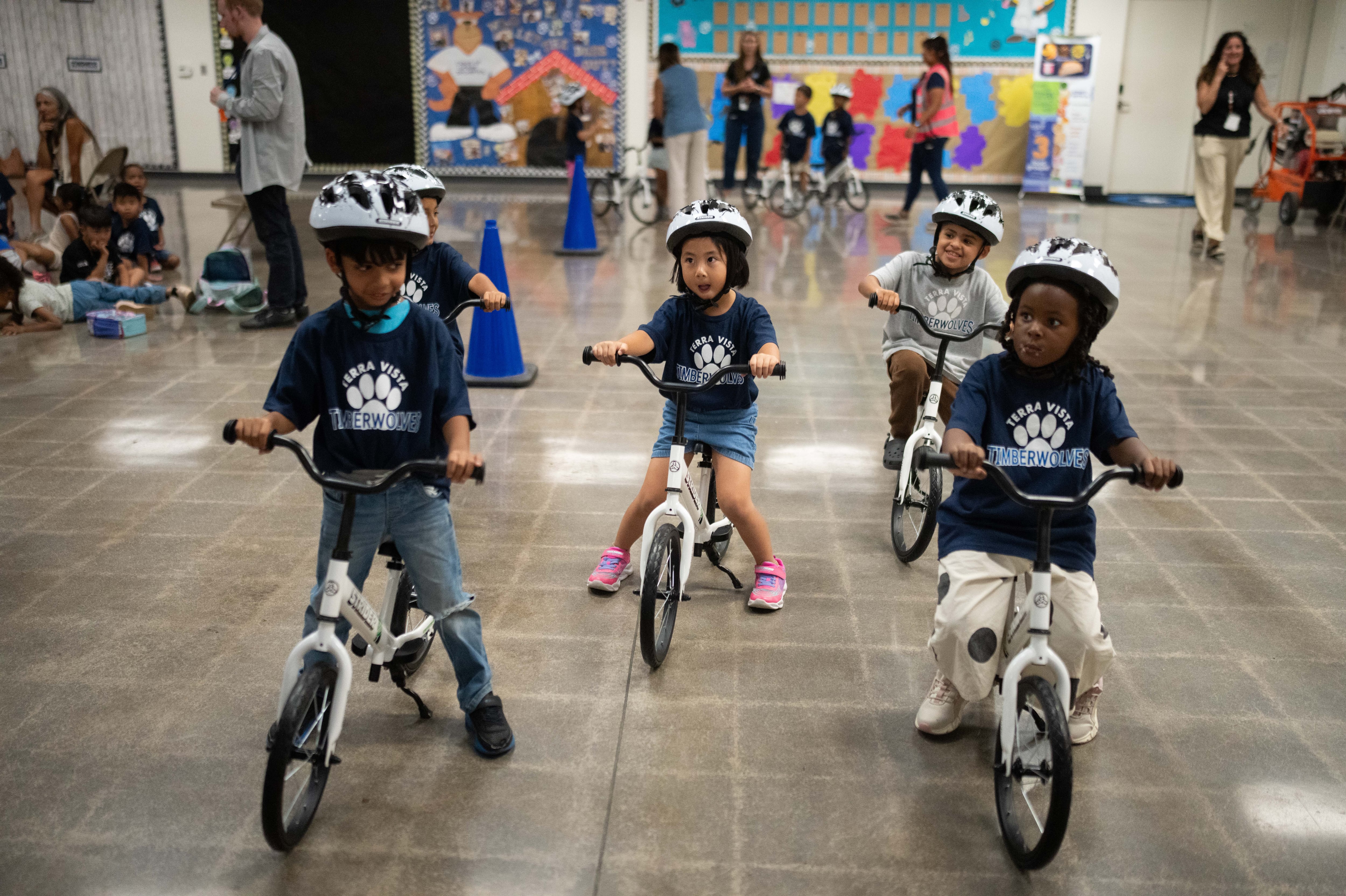 A childhood rite moves indoors as kindergartners learn to ride bikes in school gyms