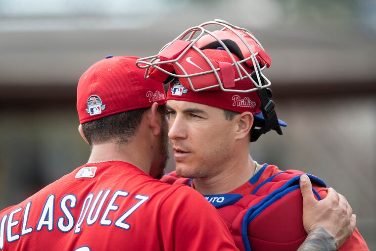 Phillies catcher J.T. Realmuto shares a few words after catching Vince Velasquez's bullpen session Sunday in Clearwater, Fla.