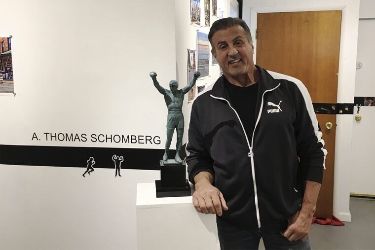 Sylvester Stallone poses with a statuette of Rocky Balboa by sculptor A. Thomas Schomberg at the Da Vinci Art Alliance in South Philadelphia in Friday, April 20, 2018.