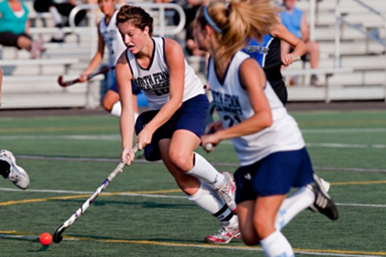 North Penn's Elizabeth Fedele, left, moves the ball up field in a game against Central Bucks South. (David M Warren / Staff Photographer)