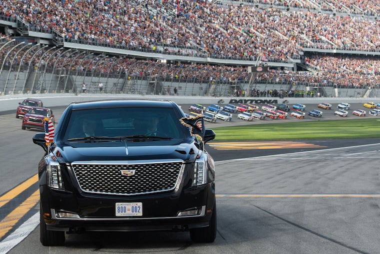 U.S. President Donald Trump and first lady Melania Trump riding in the presidential limousine during a pace lap ahead of the start of the Daytona 500.