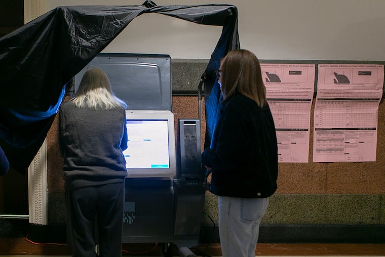 A voter learns to use new voting machines at Philadelphia City Hall before the 2019 general election.