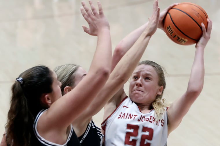 Chloe Welch (22) shoots during a game against her former team, Davidson.