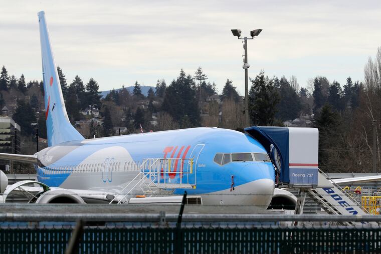 In this photo taken Monday, March 11, 2019, a Boeing 737 MAX 8 airplane being built for TUI Group sits parked at Boeing Co.'s Renton Assembly Plant in Renton, Wash. (AP Photo/Ted S. Warren)