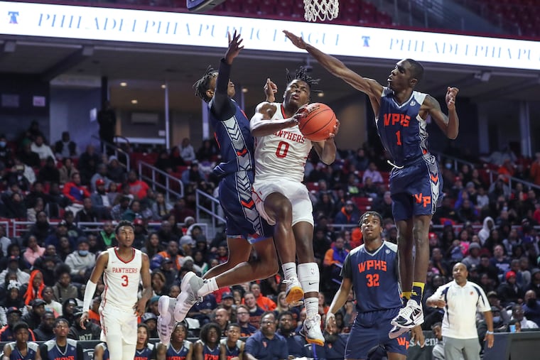 Imhotep’s Ahmad Nowell driving to the basket past West Philly defenders during the Public League championship game last February at the Liacouras Center. Nowell, a UConn commit and one of the nation's top recruits, didn't make the McDonald's All American Game roster, but he's using that as motivation.