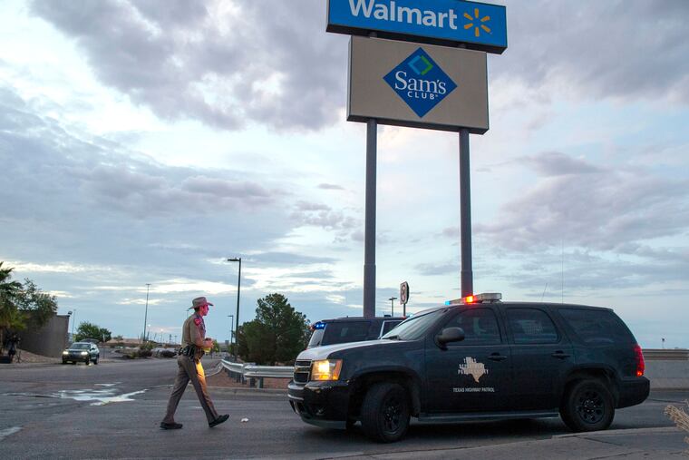 A Texas State Trooper walks back to his car while providing security outside the Walmart store in the aftermath of a mass shooting in El Paso, Texas in August. A gunman who said he was targeting Mexicans and killed 22 people at a Walmart store in El Paso, Texas, over the summer has been indicted on federal hate crimes charges, a person familiar with the matter told The Associated Press.