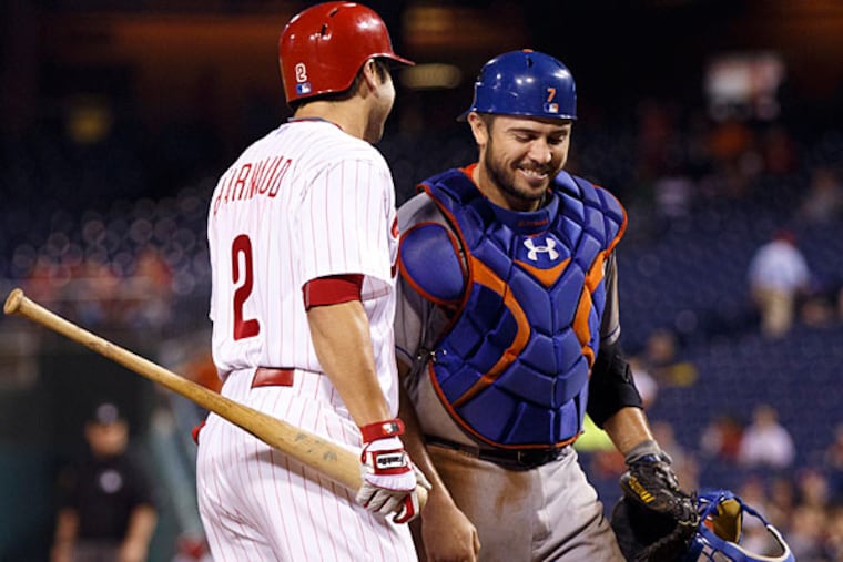 Philadelphia Phillies' Chase d'Arnaud, left, has a word with his
brother, New York Mets catcher Travis d'Arnaud, right, before his at
bat during the seventh inning of a baseball game Tuesday, Sept. 29,
2015, in Philadelphia. The Philadelphia Phillies won 4-3.