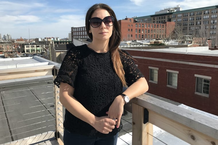 Kristin Grandzol on the roof deck of her Spring Garden home. She and her daughters are leaving the city, where they no longer feel safe after their husband and father, Gerard Grandzol, 38, was shot to death outside their home last year.