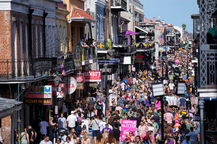 Revelers fill Bourbon Street below the balcony of the Royal Sonesta Hotel during Mardi Gras festivities in the French Quarter in New Orleans. (AP Photo/Gerald Herbert)