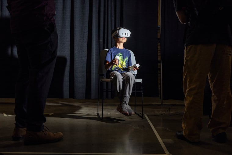 Alexander Yang, 6, of Arlington, Virginia, plays a VR-simulated game during the 2026 International Congress of Mathematicians at the Convention Center on Saturday.