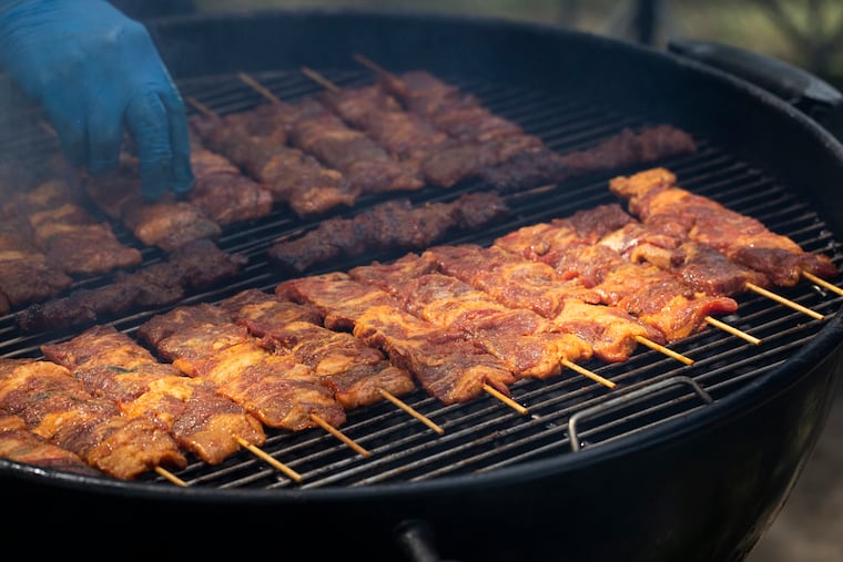 Beef skewers — one of Scannpieco's favorite snacks — on the grill at the Southeast Asian Market at FDR Park.