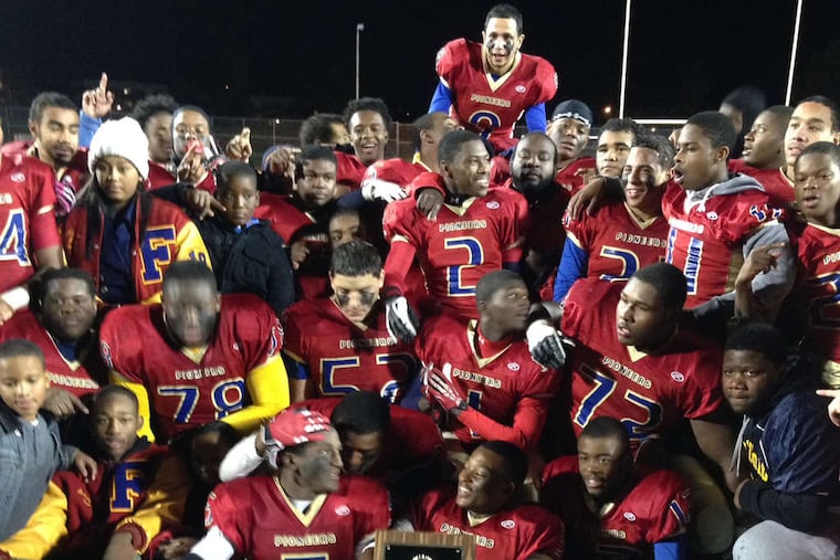 Damion Samuels (holds title plaque) with Frankford teammates. (Aaron Carter / Staff)