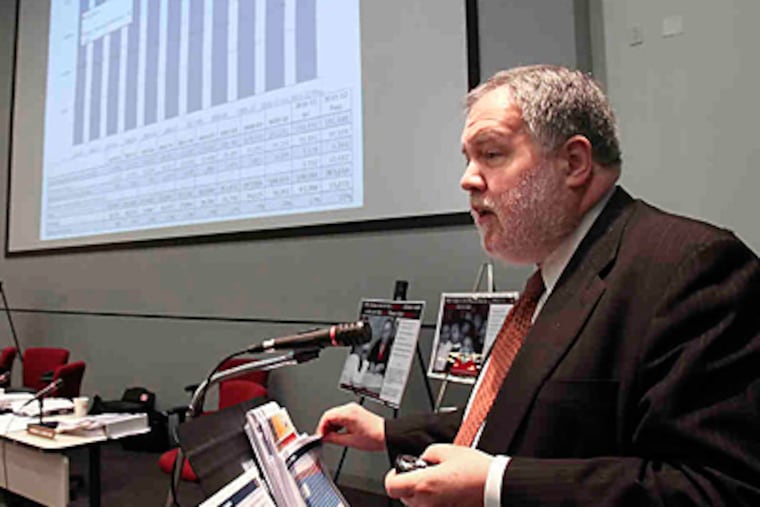 "We deeply regret the need to take this action," said Michael Masch, the Philadelphia district's chief financial officer, shown at a School Reform Commission meeting on proposed cuts.