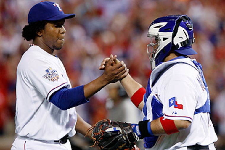 Pitcher Neftali Feliz is congratulated by catcher Bengie Molina after Game 3 of the 2010 World Series. Feliz agreed to a minor-league deal with the Phillies on Monday and will report to spring training next month. (AP Photo / Matt Slocum)