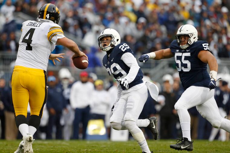 Penn State's John Reid (29) and Antonio Shelton (55) chase down Iowa quarterback Nate Stanley (4) during the first half of an NCAA college football game in State College, Pa., Saturday, Oct. 27, 2018.